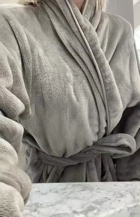 Karma stripping her bathrobe